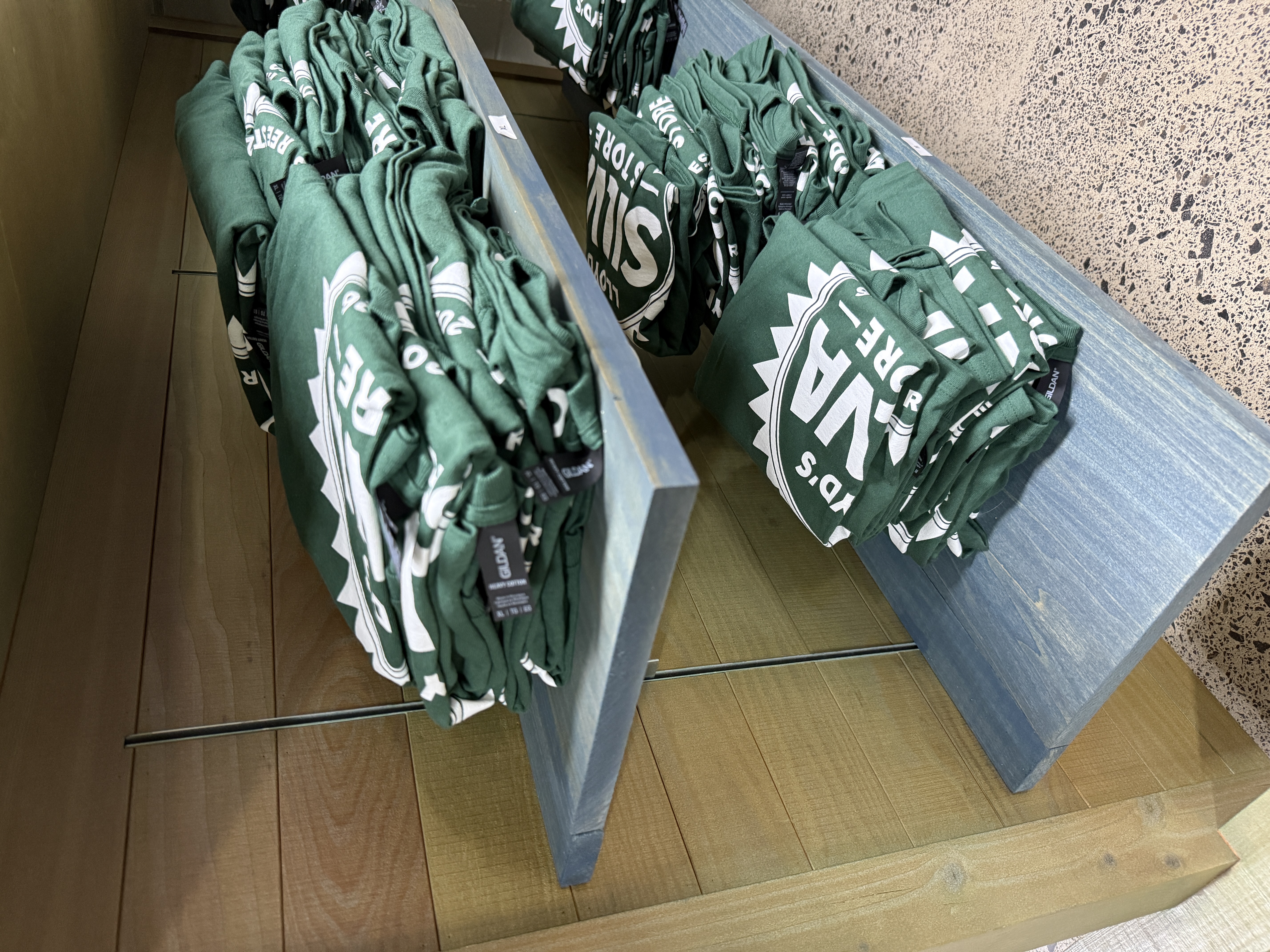 Lloyd's Silva Store green t-shirts on display