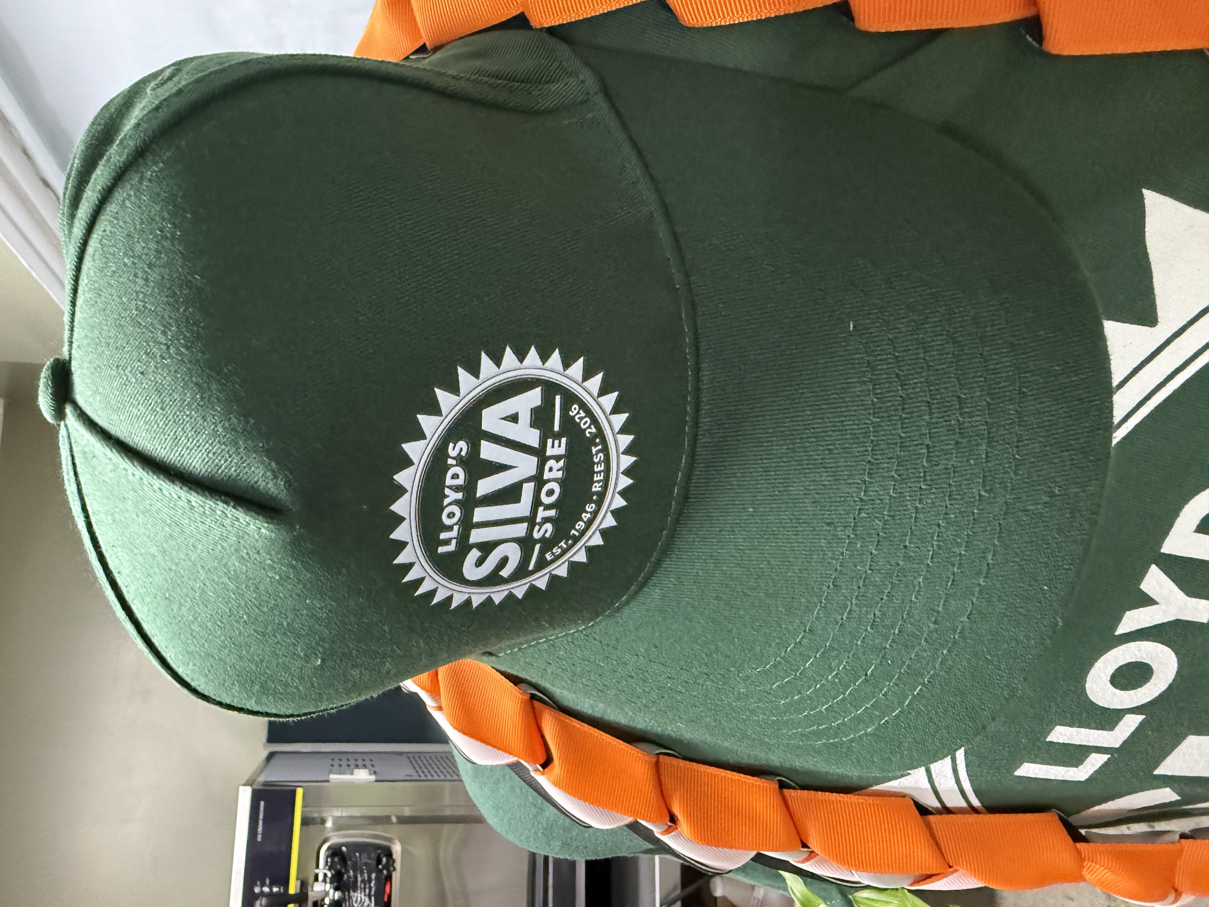 Lloyd's Silva Store branded green hat