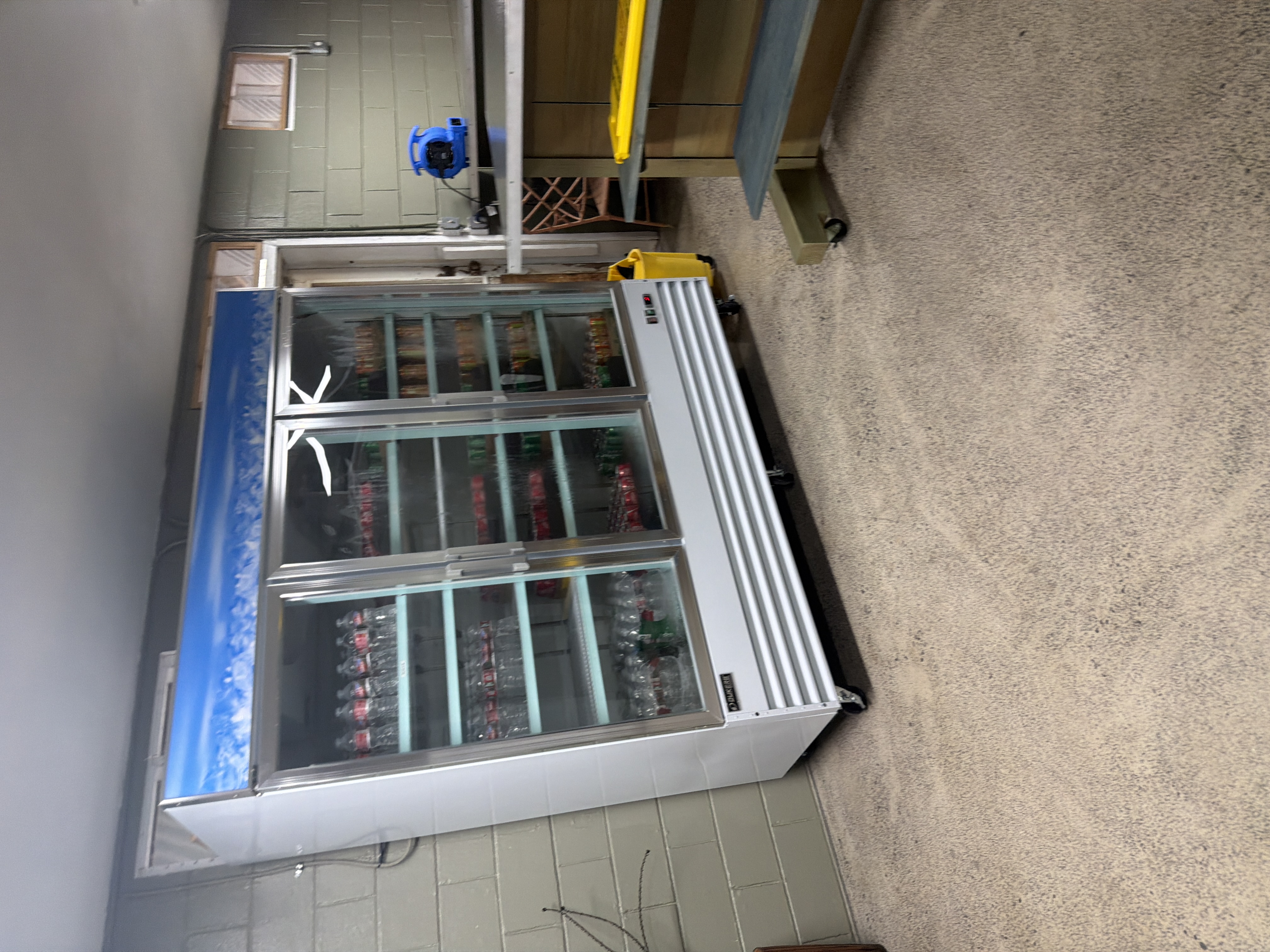 Cold drink cooler stocked with sodas and juices at Lloyd's Silva Store